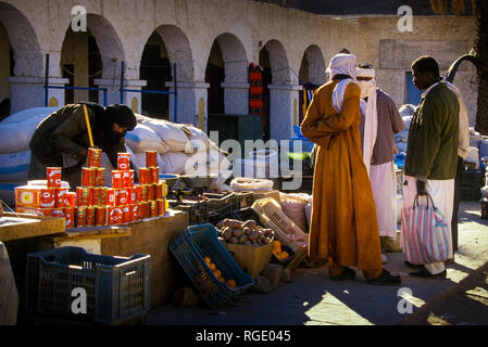 DJANET, ALGERIA - JANUARY 16, 2002: unknown vendors at the market with arch architecture Stock Photo