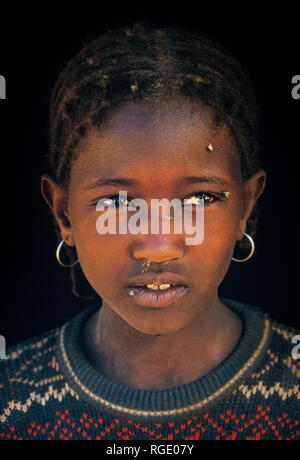 DJANET, ALGERIA - JANUARY 16, 2002: portrait of a girl at the market Stock Photo