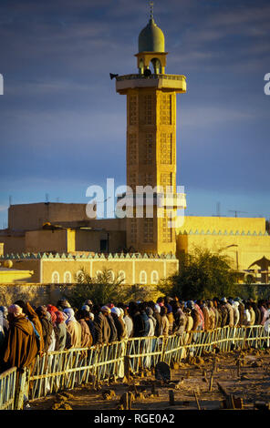 BORDJ EL HAOUAS, ALGERIA - JANUARY 16, 2002: unknown people at the time of prayer when they line up to go to the mosque Stock Photo
