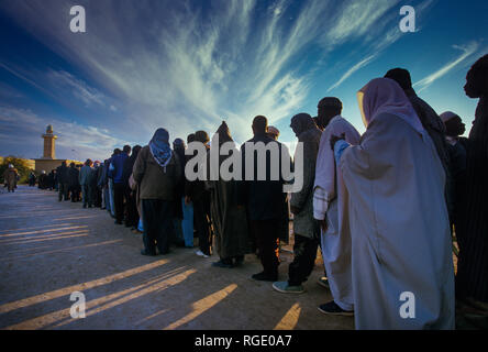 BORDJ EL HAOUAS, ALGERIA - JANUARY 16, 2002: unknown people at the time of prayer when they line up to go to the mosque Stock Photo