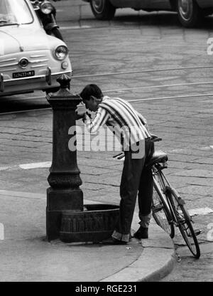 milan, boy quenches his thirst at the fountain, 1963 Stock Photo