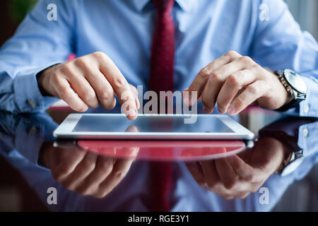Close-up of professional businessman using modern digital tablet at his office. Stock Photo