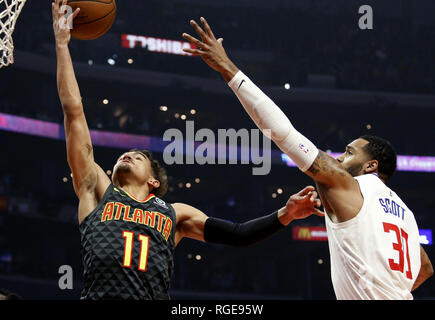 Los Angeles, California, USA. 28th Jan, 2019. Atlanta Hawks's Trae Young (11) goes to basket while defended by Los Angeles Clippers' Mike Scott (30) during an NBA basketball game between Los Angeles Clippers and Atlanta Hawks Sunday, Jan. 6, 2019, in Los Angeles. Credit: Ringo Chiu/ZUMA Wire/Alamy Live News Stock Photo