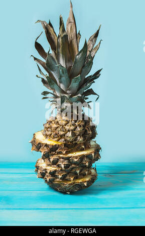 Sliced pineapple fruit on a blue background. Stock Photo