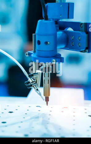 soldering iron tips of robotic system for automatic point soldering for printed and assembly electric circuit board ( PCB ) at factory Stock Photo