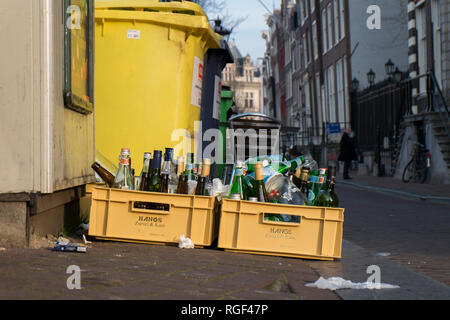 The bottles from last night's party out in the street in Amsterdam, ready for recycling. Stock Photo
