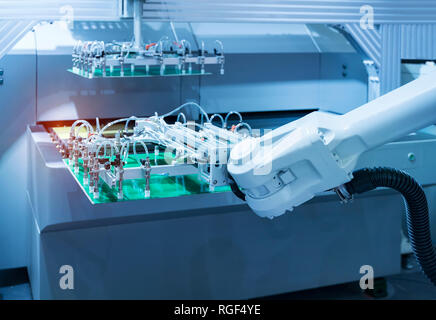Automation of machine assembly of computer circuit board with robot arm,Smart factory industry 4.0 concept. Stock Photo