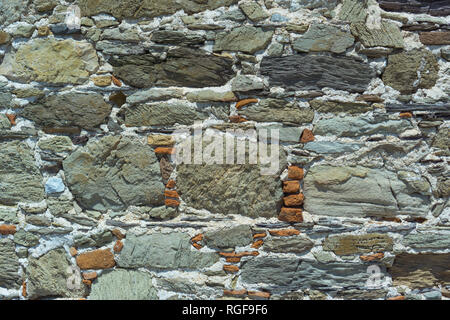 Stone wall pattern. Photo of all stone wall made from different stone types. Stock Photo