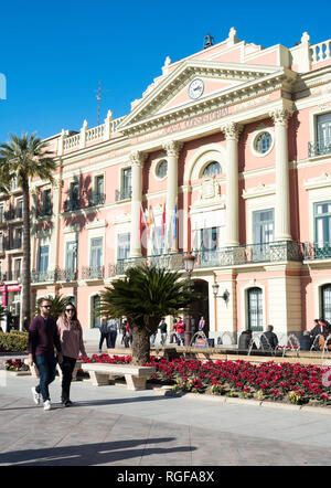 Young couple walking past the Town Hall or Casa Consistorial in Murcia, Spain, Europe Stock Photo