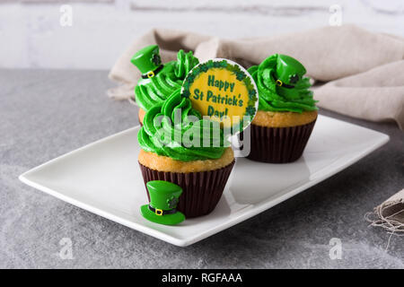 St. Patrick's Day cupcakes on gray background. Stock Photo