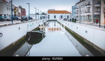Aveiro, Portugal - May 7, 2018: Small boat docked on a canal in the city on a spring day Stock Photo