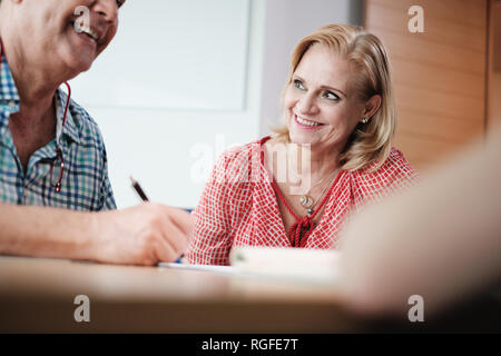 Manager Working As Banking Broker With Old Couple Signing Contract Stock Photo