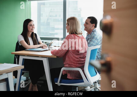 Woman Working As Investment Advisor Talking To Customers In Office Stock Photo
