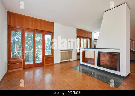 Old living room, apartment interior with fireplace in old house with garden Stock Photo