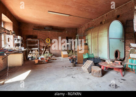 Messy basement with big barrel and red bricks walls in old country house Stock Photo