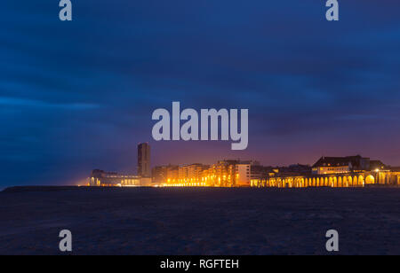 Cityscape of Ostend city at night seen from its North Sea beach, West Flanders, Belgium. Stock Photo