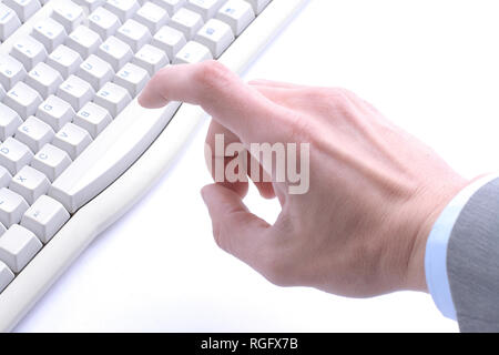 finger hit the button on the old computer keyboard Stock Photo
