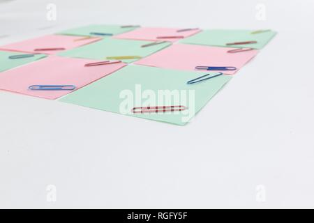 multiple blank sheets for notes with paper clips isolated on white background Stock Photo