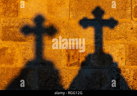 The silhouette of two crosses at sunset, concept of the catholic religion, faith and Christianity. Stock Photo