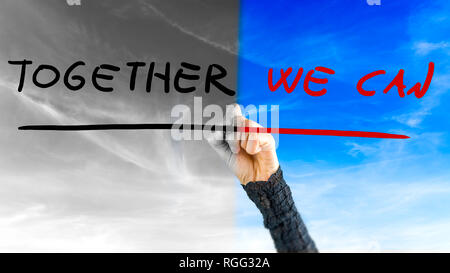 Woman reaching up to write - Together We Can - a motivational message inspiring cooperation to bring about change with a sky in the background changin Stock Photo