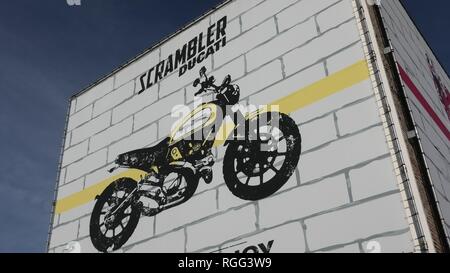 Bologna, Borgo Panigale, Italy - January 26, 2019: Ducati Scrambler motorcycle logo on the Ducati headquarter and motorcycling factory. Stock Photo