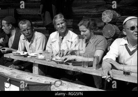 Skiers taking lunch Schwendi Klosters Switzerland 1937 Stock Photo