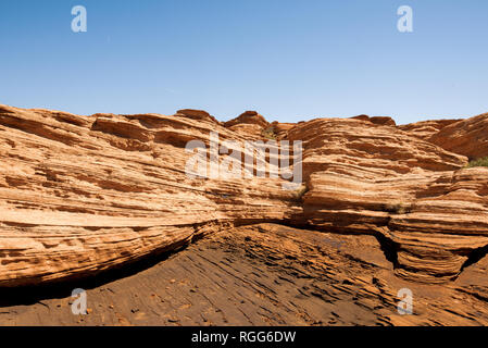 Waves of layered red rock at Horseshoe Bend in Arizona Stock Photo