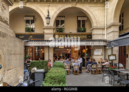 People sitting outdoors at  tables eating lunch at , Bistro Saint Dominique, a French restaurant on Rue Saint-Dominique , on a Summers's day in Paris Stock Photo