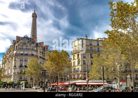The Eiffel Tower rises above elegant Parisian apartment buildings with iron balconies in 7th arrondissement of Paris Stock Photo
