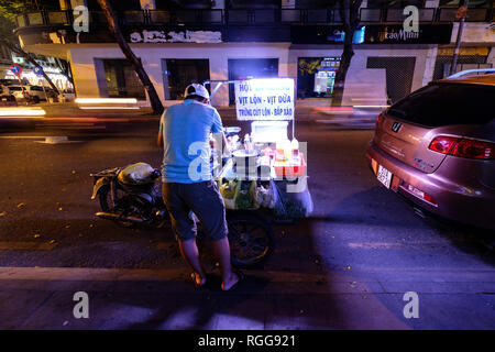 Rear view of a man at a street food stall in Hoi An, Vietnam, Southeast Asia Stock Photo