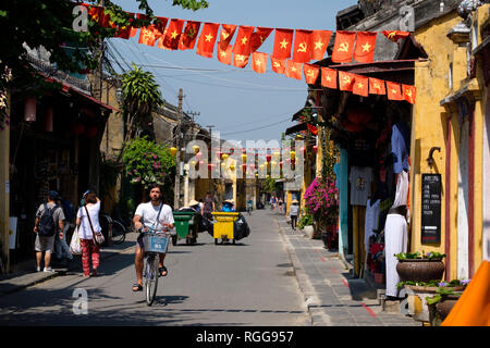 Communist Party of Vietnam flags hanging over the streets of old town Hoi An, Vietnam Stock Photo