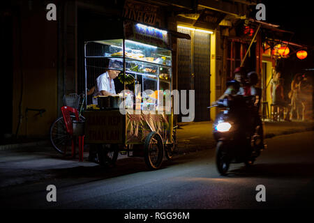 Man at a street food stall in Hoi An, Vietnam, Southeast Asia Stock Photo