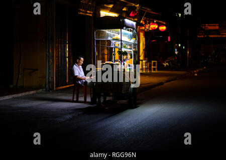 Man at a street food stall in Hoi An, Vietnam, Southeast Asia Stock Photo