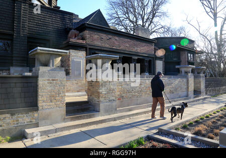 A man with a dog walking pass by Frank Lloyd Wright's Home and Studio in Oak Park.West Side of Chicago.Illinois.USA Stock Photo