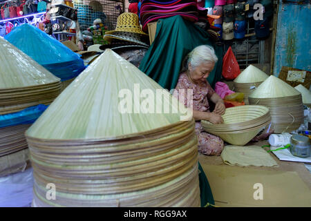 Artisan making a traditional vietnamese non la conical hat at the Dong Ba market in Hue, Vietnam, Asia Stock Photo