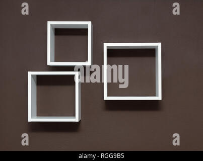 White shelves on the brown wall background Stock Photo