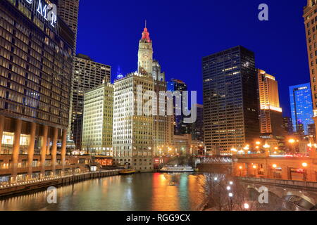 Night view of Chicago River with historical Wrigley Building in the background and Trump Hotel and Tower in foreground.Chicago.Illinois.USA