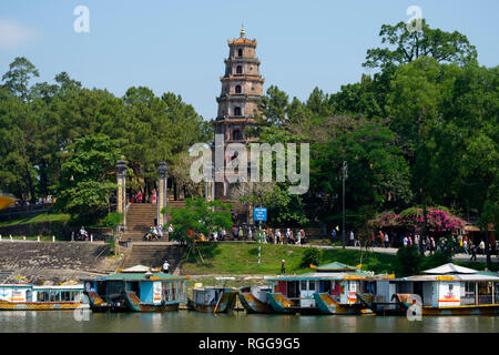 Tourism excursion boats on the Perfume river moored next to the Phuoc Duyen Tower,Thien Mu Pagoda, Hue, Vietnam, Asia Stock Photo