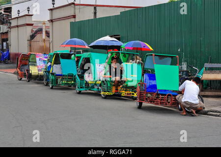Manila, Philippines-October 24, 2016: Pedicabs are the easiest way of moving around when inside the Intramuros-Walled City area. Here stationed in a r Stock Photo