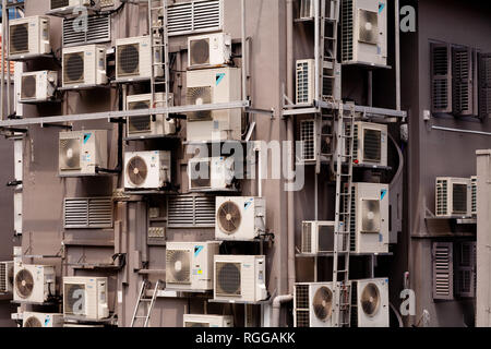 Masses of air conditioning units on the side of a block of flats, Singapore. Stock Photo