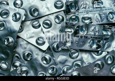 Empty used blister packs of tablets used to control high blood pressure. Medical shortage concept. Stock Photo