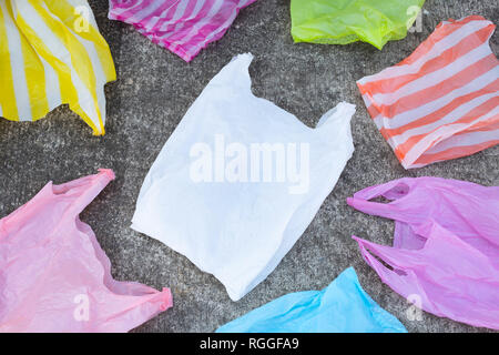 Colorful disposable plastic bags  on cement floor Stock Photo