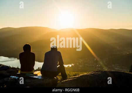 Older couple at Hochfirst with view to Titisee and Feldberg at sunset, near Neustadt, Black Forest, Baden-Württemberg, Germany Stock Photo