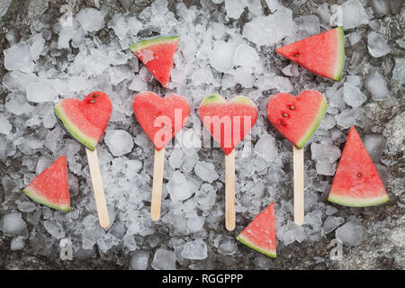 Watermelon heart ice lollies on crashed ice Stock Photo