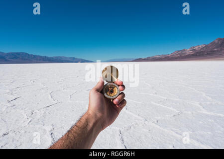 USA, California, Death Valley, man's hand holding compass Stock Photo