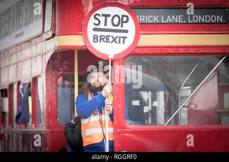 A man holds a 'Stop Brexit' sign aboard a campaign bus travelling down Whitehall in Westminster, London as a crucial debate on Brexit gets underway. Stock Photo