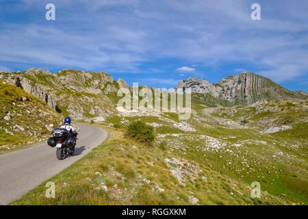 Motorcycle on mountain road, Gruta and Prutas mountains, Durmitor massif, Durmitor National Park, Pluzine province, Montenegro Stock Photo