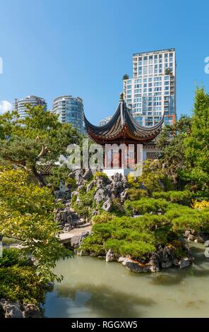 Traditional Chinese Pagoda in Dr. Sun Yat-Sen Classical Chinese Garden, in front of skyscrapers, Vancouver, British Columbia Stock Photo