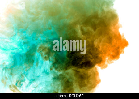 A thick column of smoke rises up as a cloud exhaled from a vape on a white background is highlighted in yellow and blue color. Stock Photo