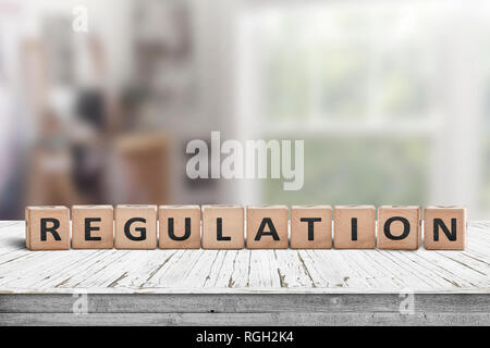 Regulation sign on a wooden table in a bright offive in daylight Stock Photo
